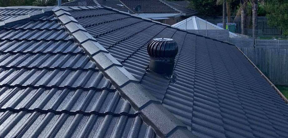 Restored tile roof with fresh coating and repointed ridge caps